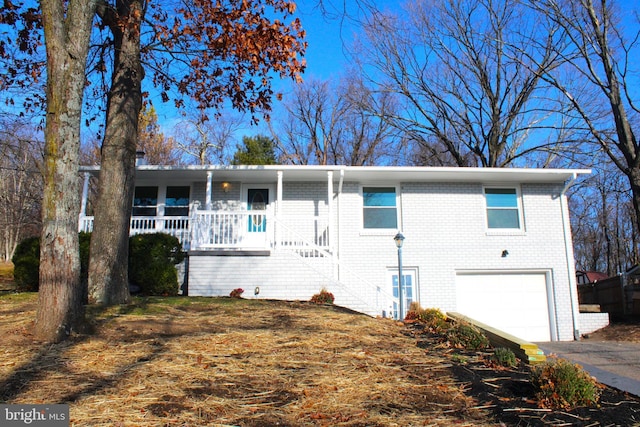 view of front facade featuring covered porch and a garage