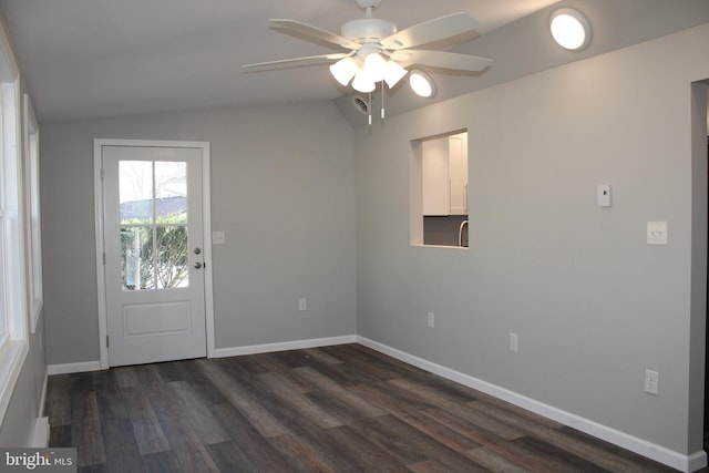 interior space with ceiling fan, sink, dark hardwood / wood-style floors, and lofted ceiling