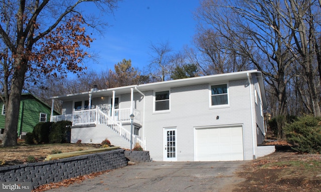 view of front of property with a porch and a garage