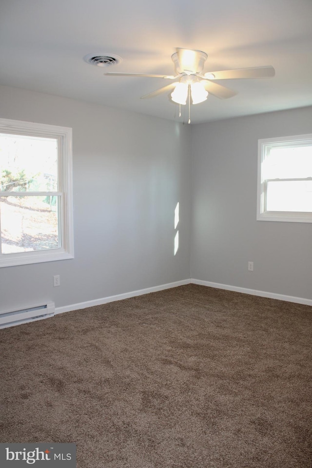 carpeted spare room with ceiling fan, a healthy amount of sunlight, and a baseboard radiator