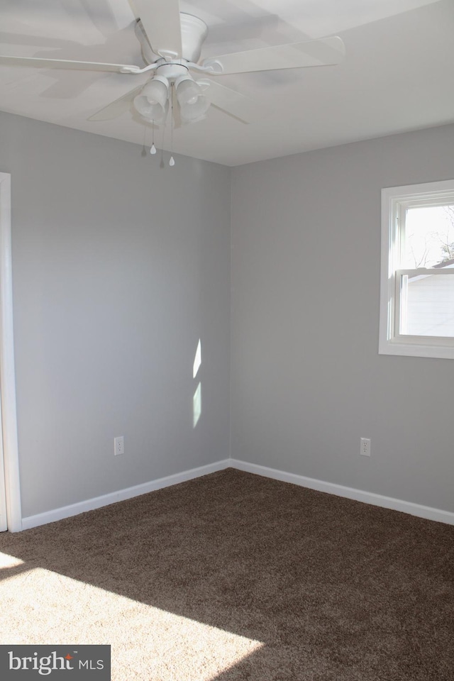 spare room featuring carpet flooring and ceiling fan