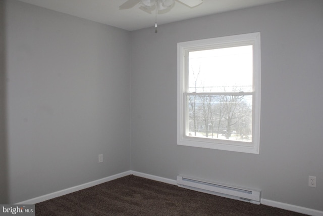 empty room featuring dark colored carpet, baseboard heating, and ceiling fan