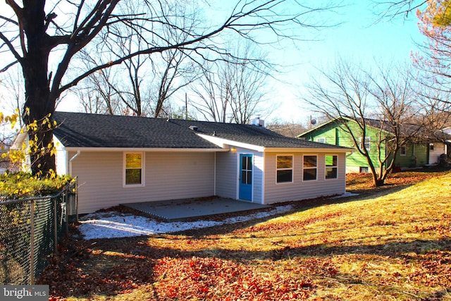 back of property featuring a lawn and a patio area