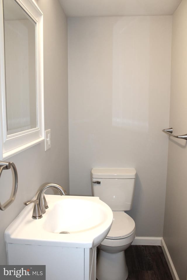 bathroom featuring hardwood / wood-style flooring, toilet, and sink