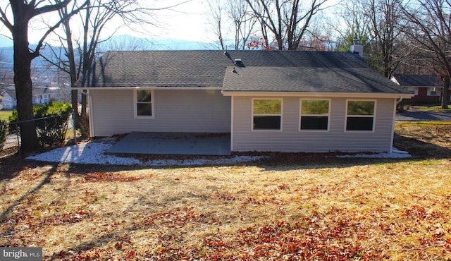 rear view of house with a yard and a patio