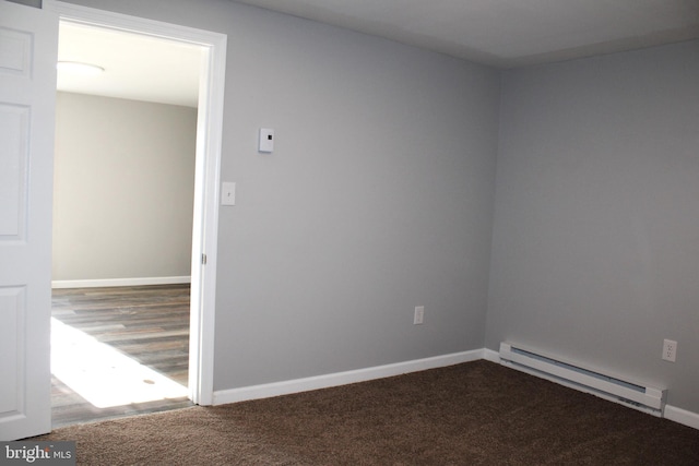 spare room with hardwood / wood-style flooring and a baseboard radiator