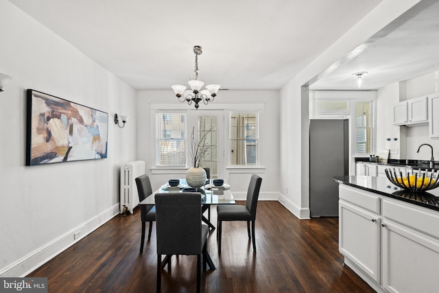 dining room with a chandelier, radiator heating unit, and dark hardwood / wood-style flooring