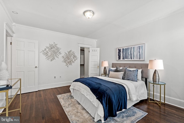 bedroom featuring crown molding and dark hardwood / wood-style flooring