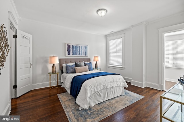 bedroom with dark wood-type flooring and ornamental molding