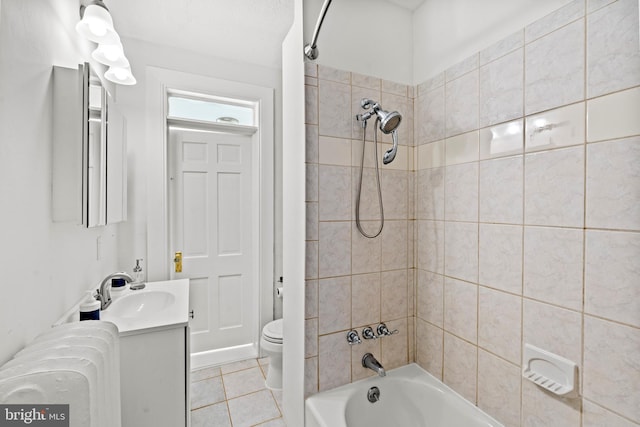 full bathroom featuring tile patterned floors, vanity, radiator heating unit, toilet, and tiled shower / bath