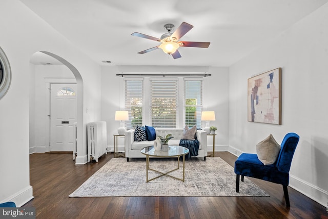 sitting room with radiator heating unit, dark hardwood / wood-style floors, and ceiling fan