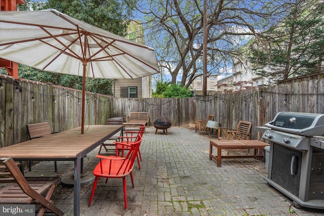 view of patio with a grill and an outdoor fire pit