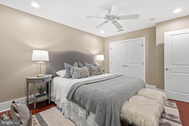 bedroom with ceiling fan, a closet, and dark hardwood / wood-style floors