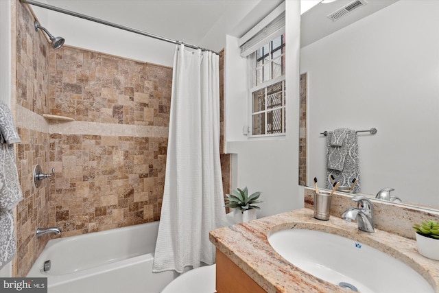 full bathroom featuring shower / bath combo with shower curtain, vanity, and toilet