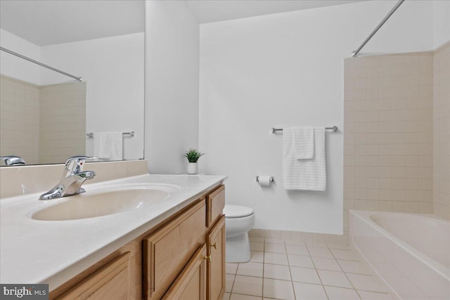 full bathroom featuring tiled shower / bath combo, vanity, tile patterned floors, and toilet