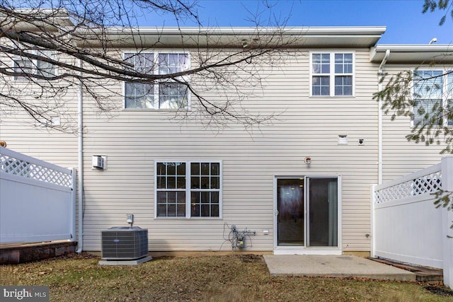 back of property featuring central AC unit and a patio