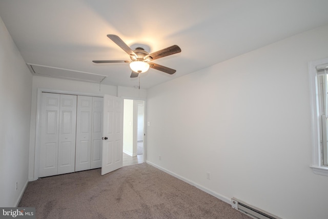 unfurnished bedroom with carpet flooring, ceiling fan, baseboard heating, and a closet