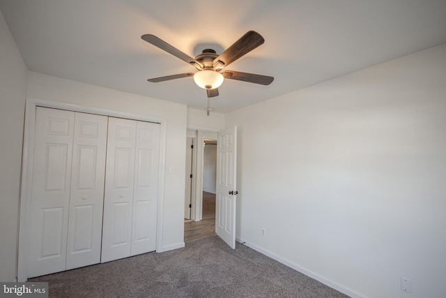 unfurnished bedroom with carpet flooring, ceiling fan, and a closet