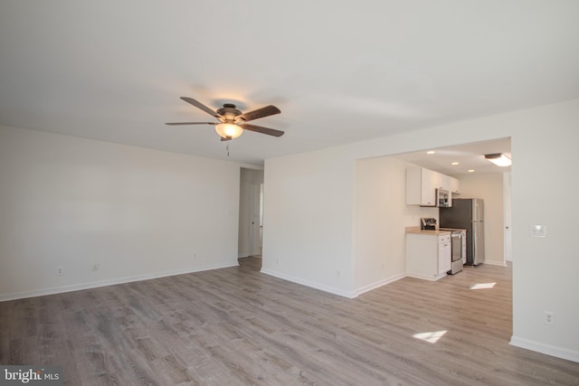 unfurnished living room with ceiling fan and light hardwood / wood-style flooring