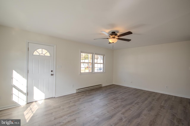 entrance foyer featuring light hardwood / wood-style flooring, baseboard heating, and ceiling fan