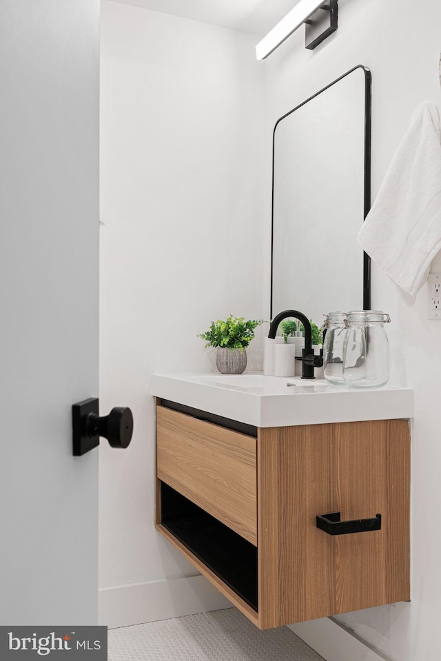 bathroom with tile patterned flooring and vanity