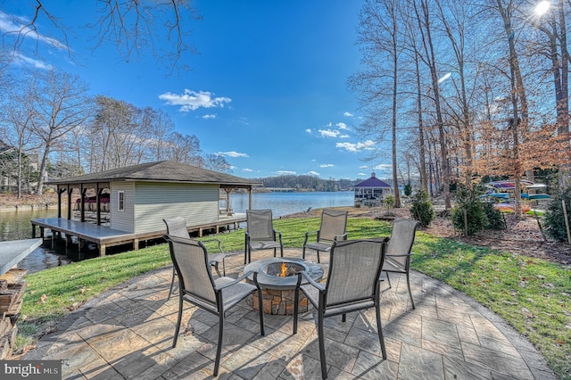 view of patio / terrace with a gazebo, a water view, and an outdoor fire pit