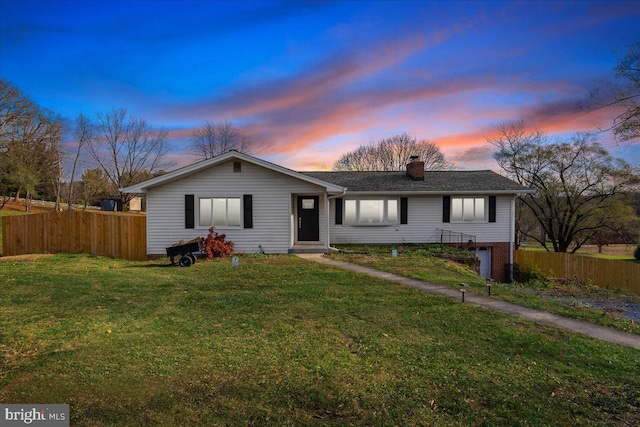 ranch-style house featuring a lawn