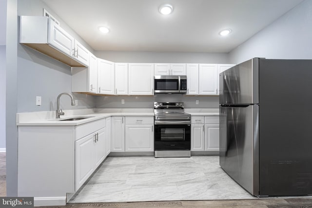 kitchen with white cabinets, sink, and stainless steel appliances