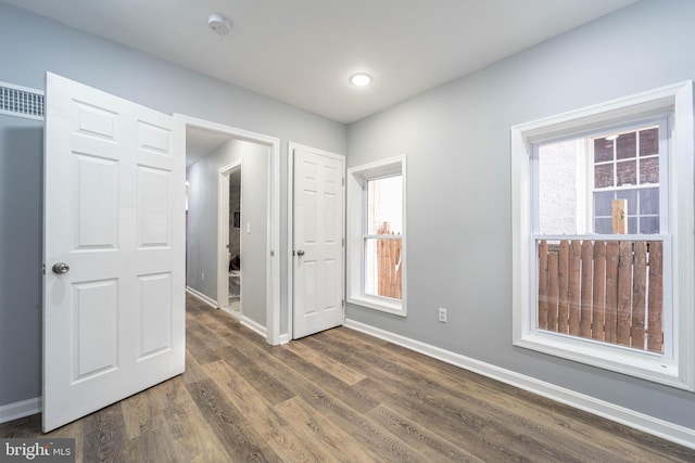 unfurnished bedroom featuring dark wood-type flooring