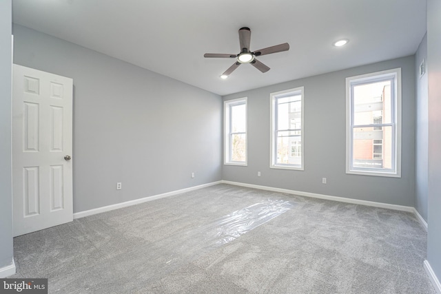 spare room with light carpet and ceiling fan