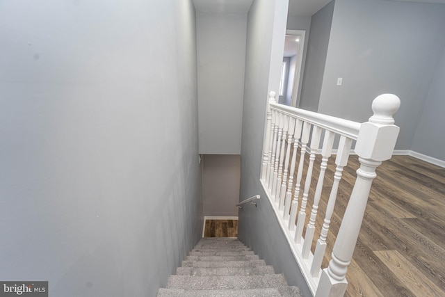 stairs featuring wood-type flooring