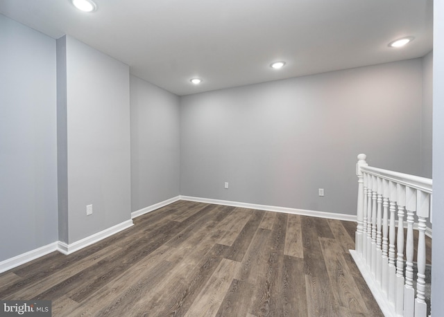 unfurnished room featuring dark wood-type flooring