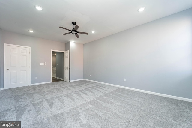 unfurnished bedroom featuring ceiling fan and light carpet