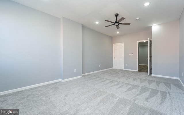 carpeted spare room featuring ceiling fan