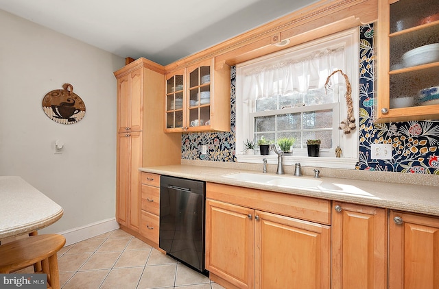 kitchen featuring dishwasher, light tile patterned flooring, decorative backsplash, and sink