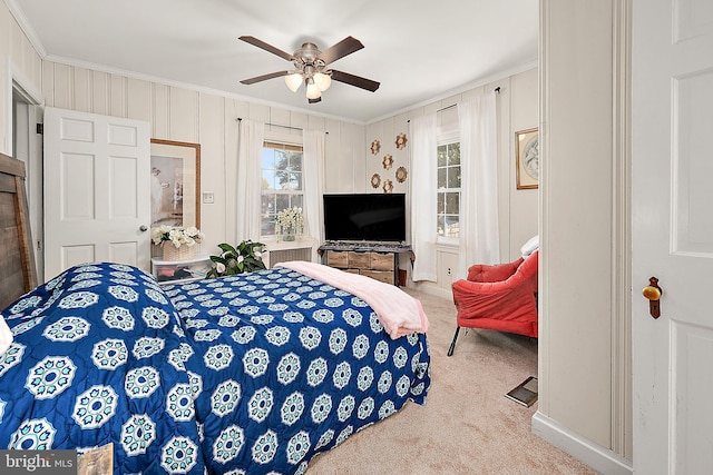 bedroom with ceiling fan, light carpet, and ornamental molding