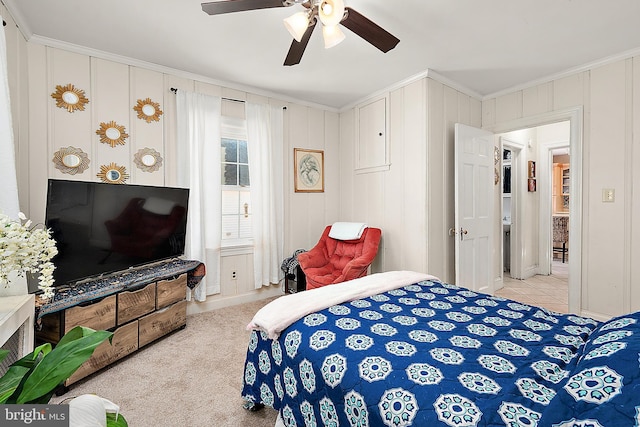 bedroom featuring ceiling fan, ornamental molding, and light carpet