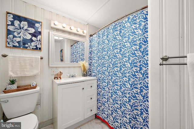 bathroom featuring tile patterned flooring, a shower with curtain, vanity, and toilet