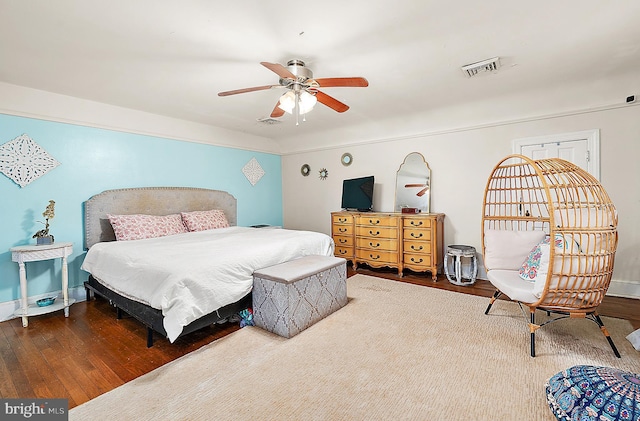 bedroom with ceiling fan and dark hardwood / wood-style flooring