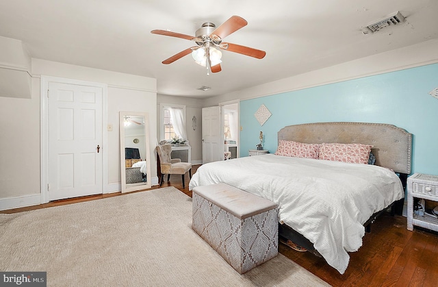 bedroom with ceiling fan and dark hardwood / wood-style floors