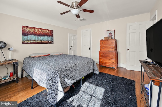 bedroom with ceiling fan and wood-type flooring