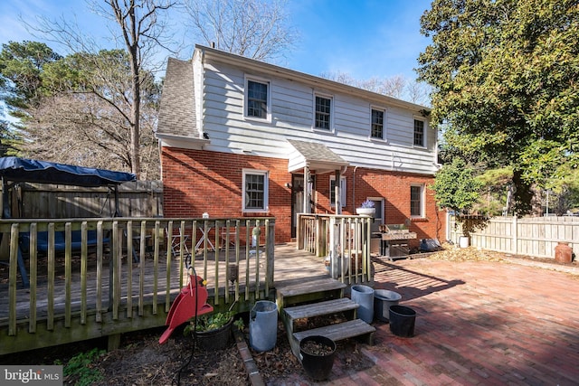 rear view of property with a wooden deck