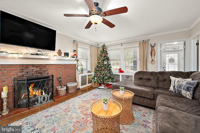 living room with a fireplace, crown molding, hardwood / wood-style floors, and ceiling fan