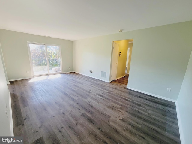 spare room with dark hardwood / wood-style flooring