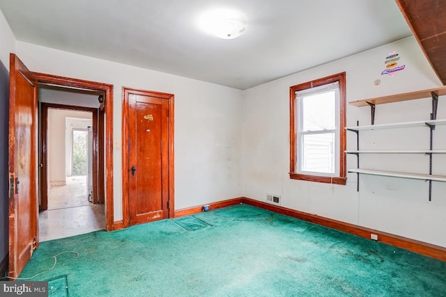 unfurnished room featuring plenty of natural light and carpet floors