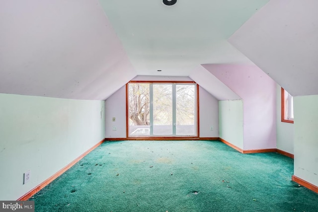 additional living space featuring carpet, lofted ceiling, and a wealth of natural light