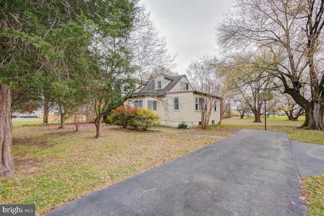 view of side of home with a yard