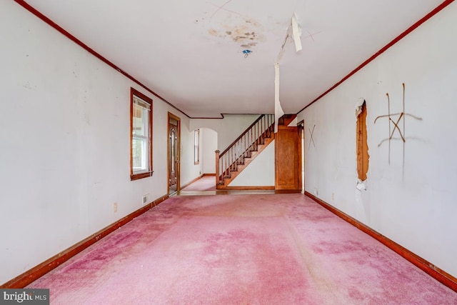 carpeted empty room with crown molding