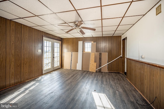 unfurnished room featuring french doors, ceiling fan, dark hardwood / wood-style flooring, and plenty of natural light