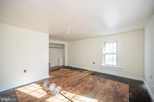 unfurnished room featuring dark hardwood / wood-style floors